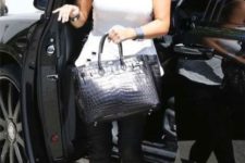 15 Kim Kardashian rocking black leather leggings, a white peplum top, black heels and a black crocodile leather bag