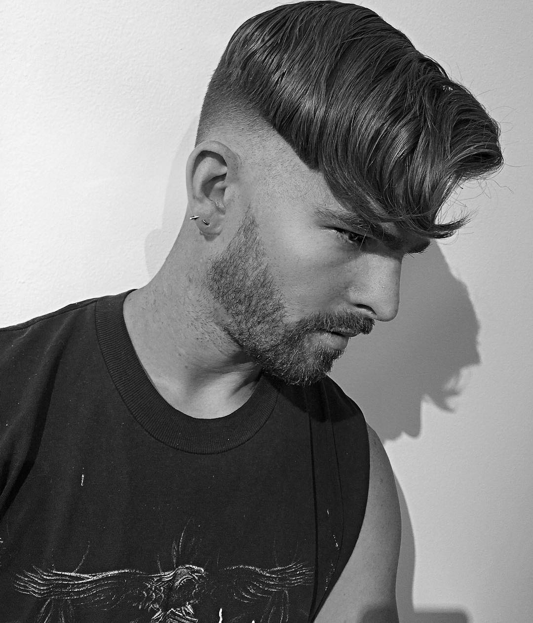 A undercut with thick wavy hair looks neat on top and bold thanks to the fade