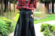 With black midi skirt, green clutch and black platform shoes