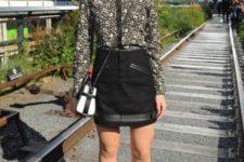 With black mini skirt, chain strap bag and black cutout boots