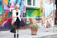 With black shirt, white blazer, black bag and ankle boots