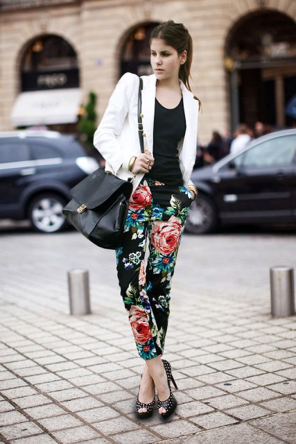 With black top, white blazer, black bag and floral pants