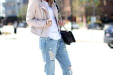 With distressed cuffed jeans, beige jacket, white shirt and black bag