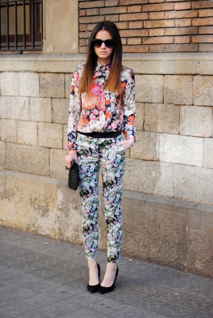 With floral pants, black clutch and black high heels