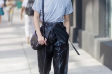 With gray loose t-shirt, black bag and purple mules