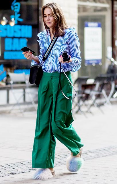 With green wide leg trousers, fur shoes and crossbody bag