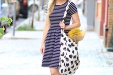 With hat, striped dress and printed tote bag