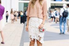 With peach loose sweater, small bag and red high heels
