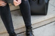 With sweater, distressed pants and black bag