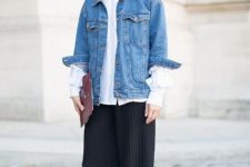 With white loose button down shirt, clutch, wide leg trousers and sneakers