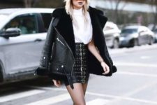 With white loose shirt, leather jacket and black boots