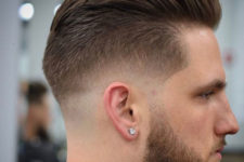 a low bald fade with slicked back hair with beard adds contrast and looks chic