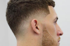 a low fade haircut features much texture on the sides and this beard accents the look even more