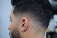 a low skin fade with a messy top is a simple and cute idea for thick hair