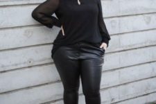 04 a black blouse with a drop cutout, black leather leggings, black lace up shoes for a party
