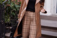 05 checked wideleg pants, a black top, nude shoes and a brown leather trench by Amal Clooney