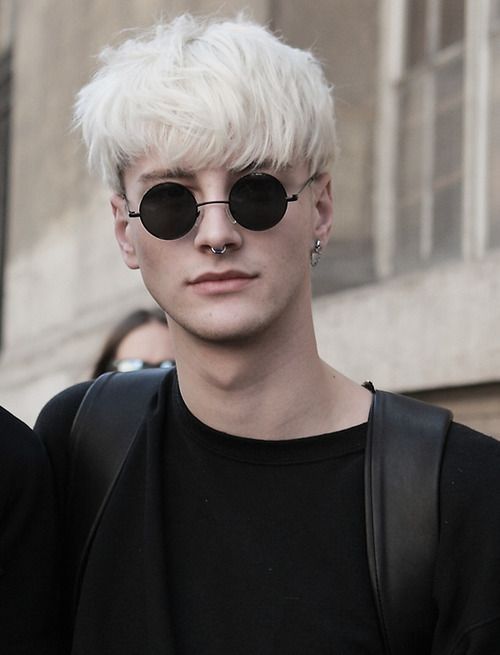 icy blonde hair, longer on top and shorter on the sides plus piercing for a catchy rock look