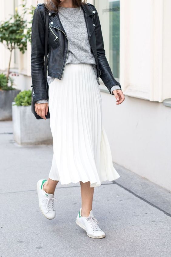 a grey tee, a white pleated midi, a black leather jacket and white sneakers