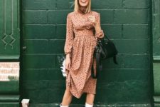 07 a pink polka dot midi dress, a black bag and white tall boots for an effortlessly girlish look