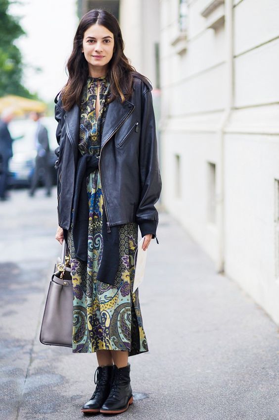 a vintage print midi dress, an oversized leather jacket, black boots and a grey bag