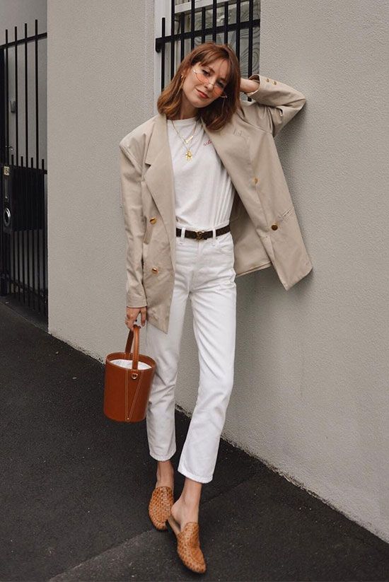 a white tee, white cropped jeans, a tan blazer, a brown bucket bag and brown loafer mules