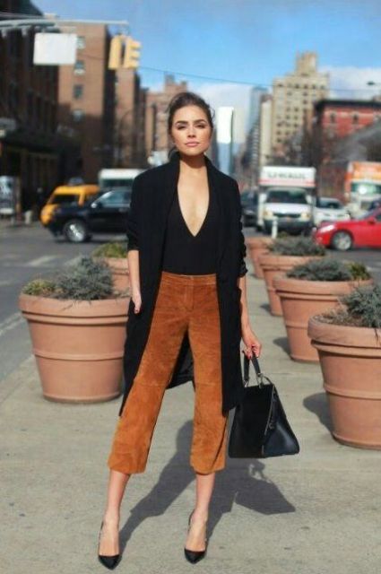 a black top, a black trench, camel suede cropped pants, black heels and a bag for work