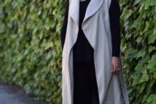 12 a chic look with black leggings, a black top, black heels and a bag and an off-white duster