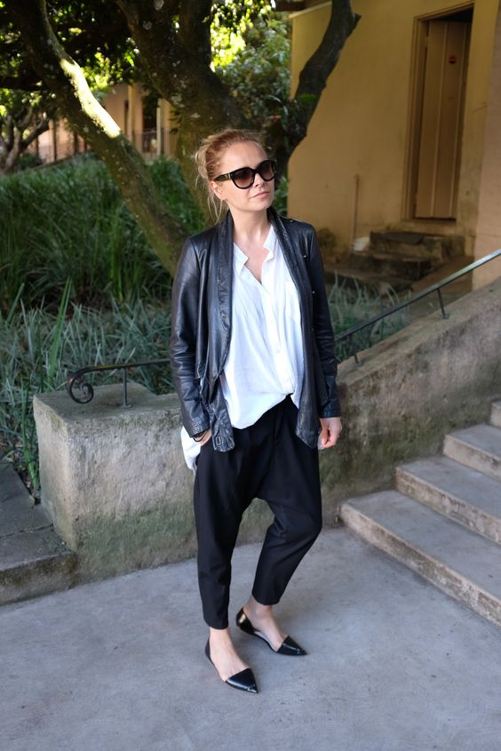 black pants, an oversized shirt, a black leather jacket and black pointed toe flats