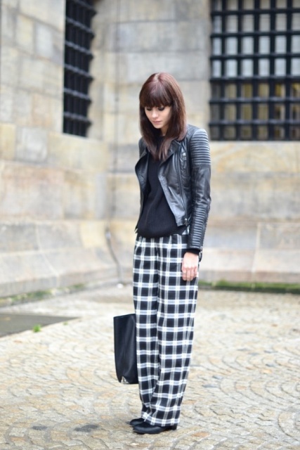 With black blouse, black leather jacket, black shoes and tote