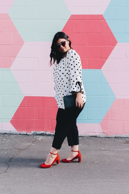 With black cropped trousers, black clutch and red shoes