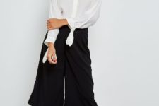 With black culottes and white platform sneakers