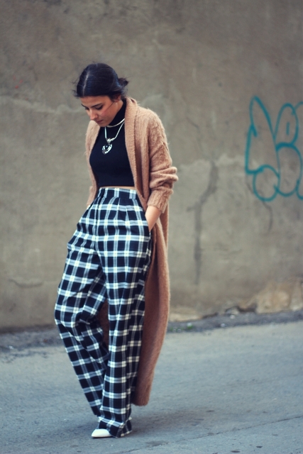 With black turtleneck, brown maxi cardigan and white shoes