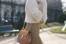 With white loose sweater and chain strap bag