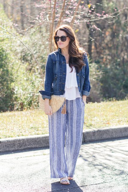 With white ruffled blouse, denim jacket, straw clutch and flat shoes