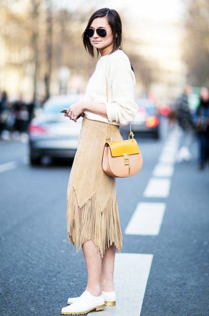 With white shirt, beige and yellow bag and white flat shoes
