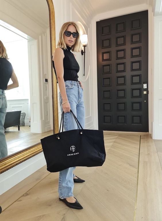 a black halte rneck top, bleached jeans, black flat slingbacks and a black tote for every day