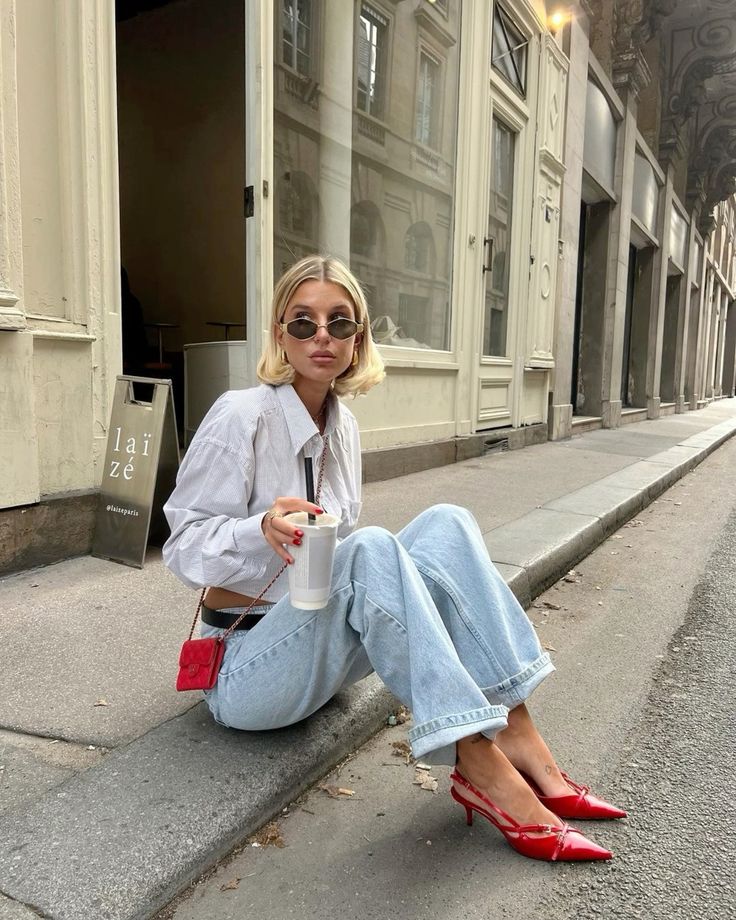 a bright and cool look with a white button down, bleached jeans, red slingbacks and a small red bag