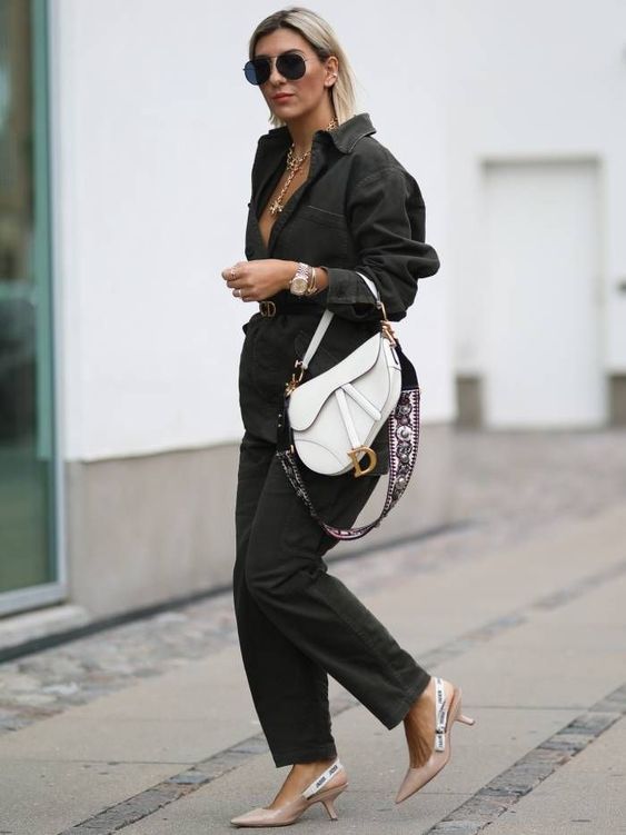 a classy work outfit with a black blazer and pants, a black belt, a white saddle bag and beige slingbacks