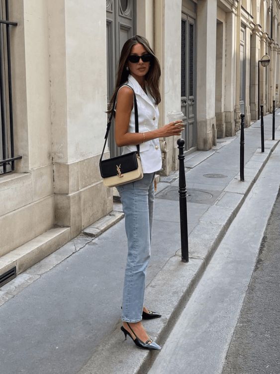 a lovely summer work look with a white suit vest, blue jeans, black slingbacks, a two-tone bag