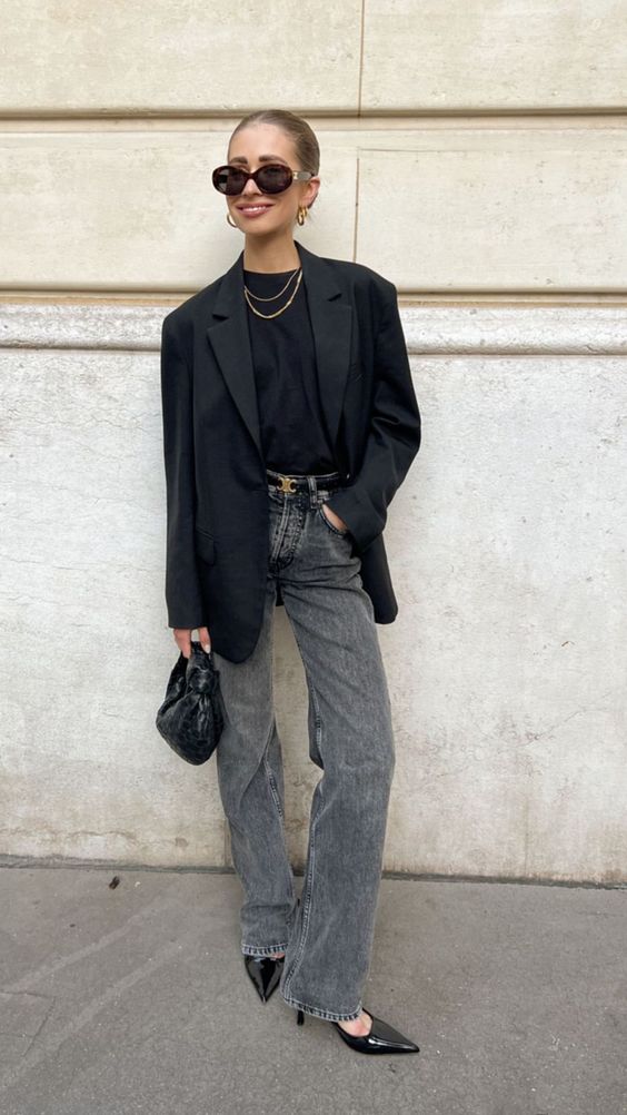 a monochromatic look with a black top, blazer, slingbacks and bag plus grey jeans and a black belt