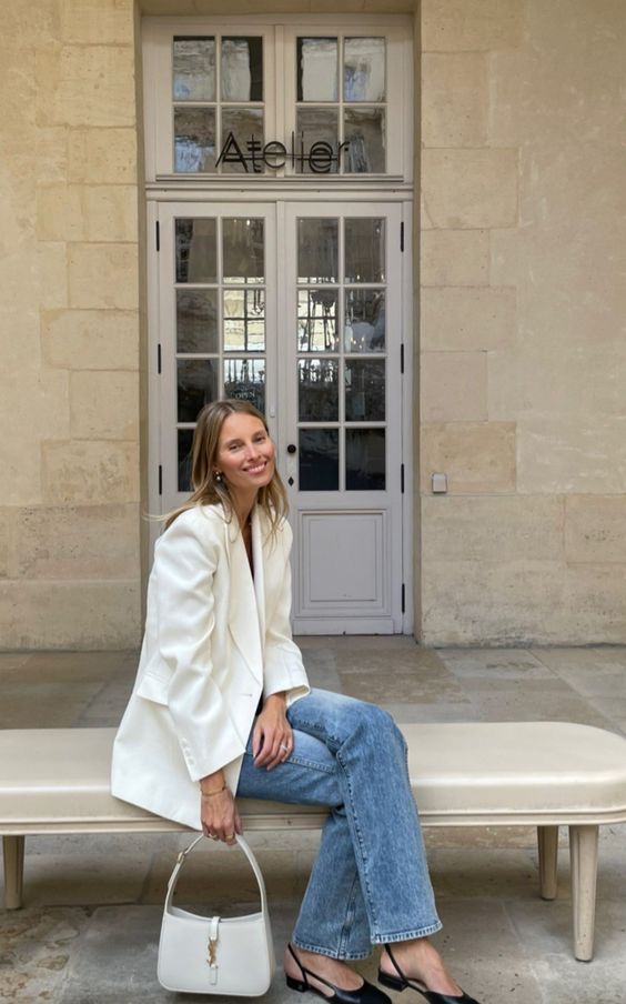 a pretty spring look with an oversized creamy blazer, blue jeans, black slingbacks and a creamy baguette bag
