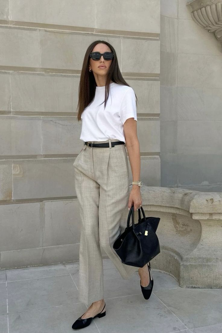 A summer work outfit with a white t shirt, grey pants, a black belt, slingbacks and a tote is easy to repeat