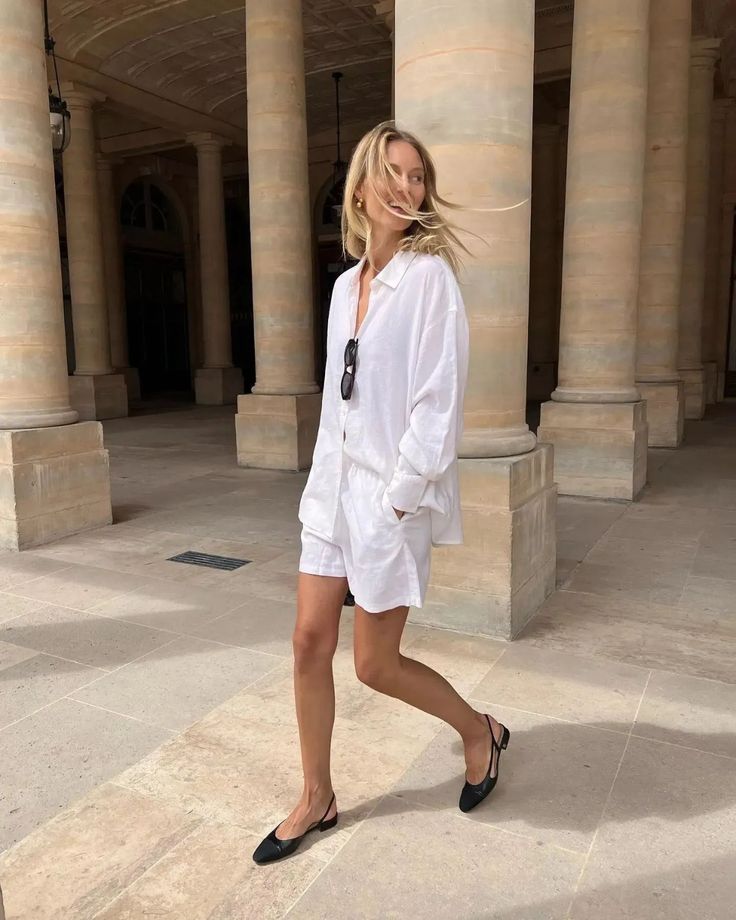 a vacation outfit with a white button down and shorts, black slingbacks and sunglasses – you won’t need more