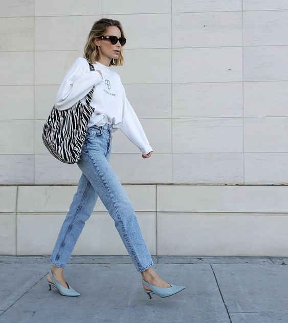 a white sweatshirt, blue jeans, blue slingbacks and a zebra print bag are a lovely look for every day