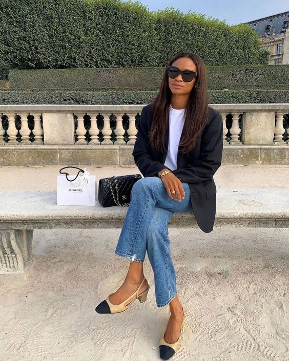 a white t-shirt, blue jeans, a black oversized blazer, two-tone shoes and a black bag are a chic look for spring