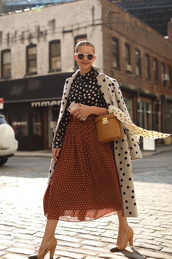 an all-polka dot outfit with a blouse, a midi skirt, a coat and nude and black heels for a retro feel