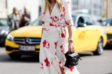 11 a neutral wrap dress with a bright floral print, white sneakers and a small black bag