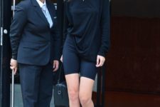 16 Gigi Hadid nailing bike shorts with a black top,  black sock boots and layered necklaces
