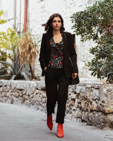 With black blazer, black crop pants, bag and red boots