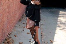 With black one shoulder blouse, black embellished bag and black and white sneakers
